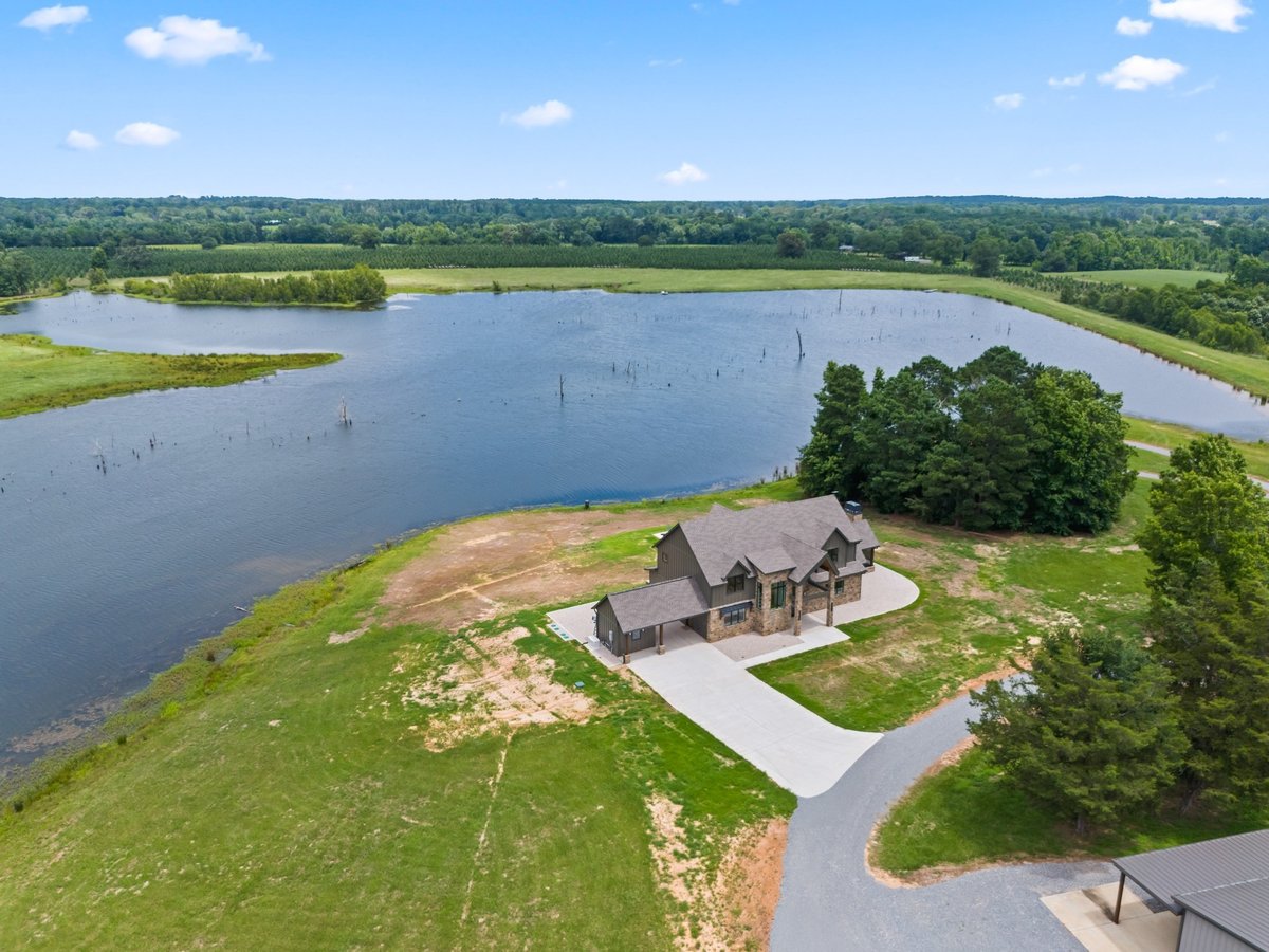 aerial view of lakefront acreage and custom home in longview texas custom home