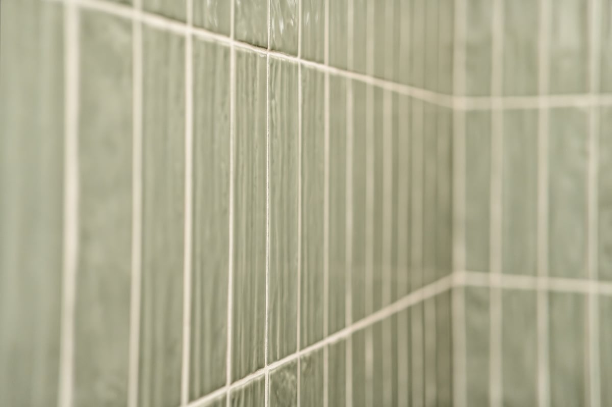 close up of glossy green shower wall tile in longview texas custom home