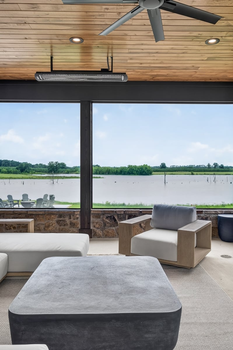 covered outdoor living space with lake views in longview texas custom home