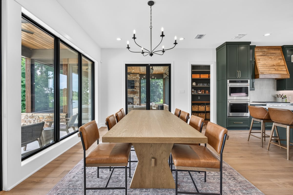 dining room with wood table and lake views in longview texas custom home