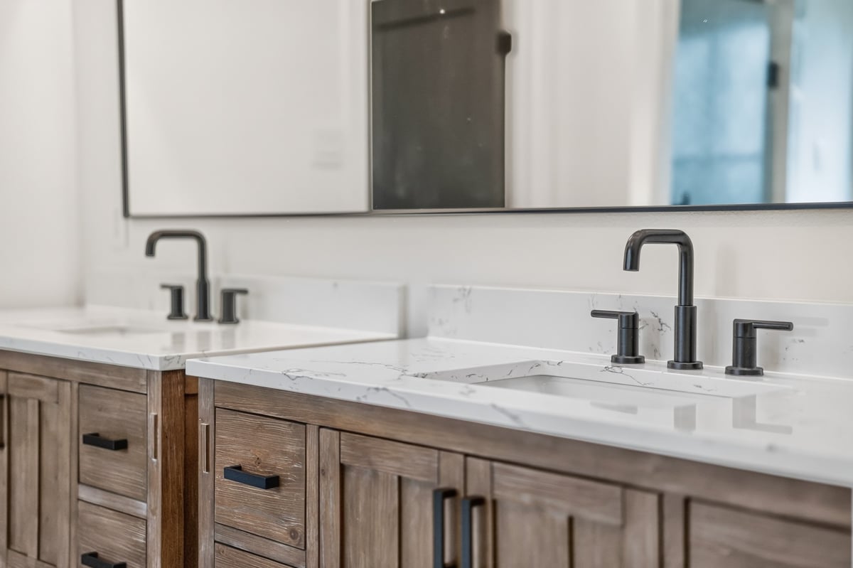double vanity with quartz countertops and black fixtures in longview texas custom home
