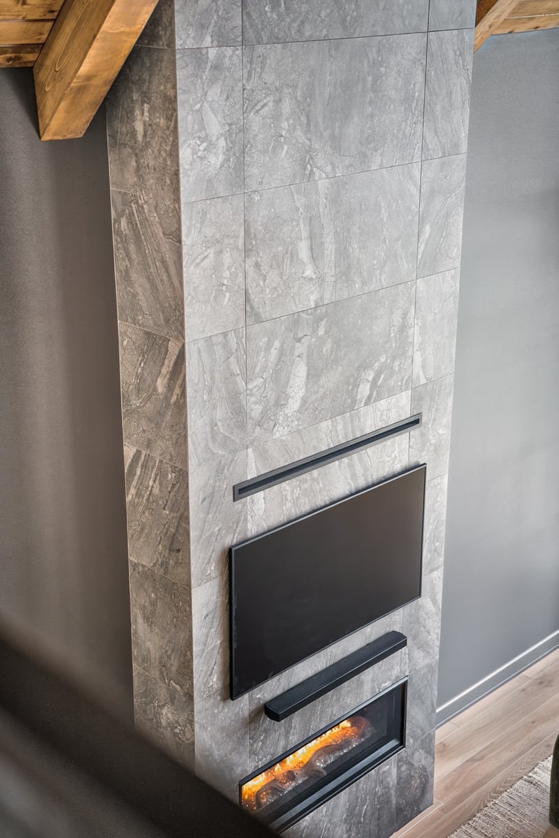 floor to ceiling stone fireplace with mounted tv in longview texas custom home