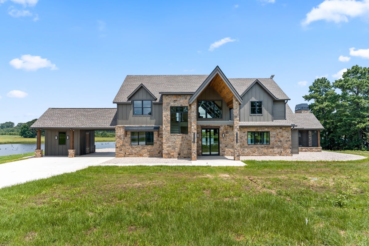 front exterior elevation with stone and board and batten siding in longview texas custom home