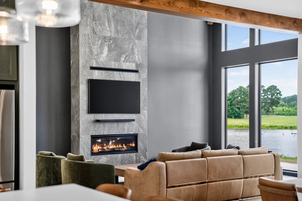 great room with stone fireplace and lake views in longview texas custom home