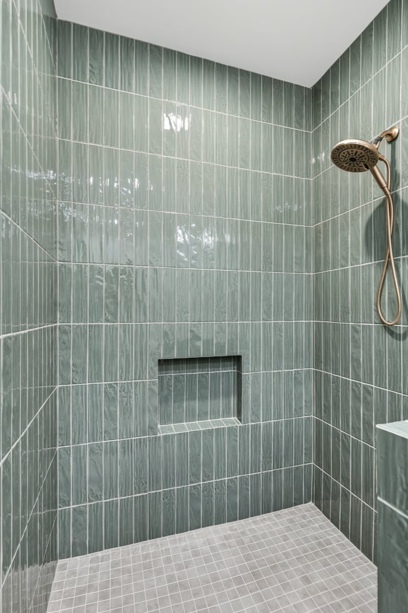 green tile walk in shower with built in niche in longview texas custom home