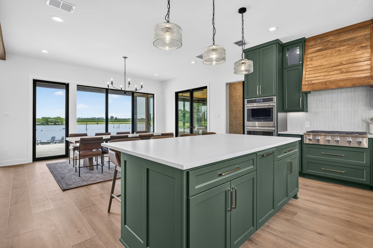 kitchen island and dining area with lake views in longview texas custom home