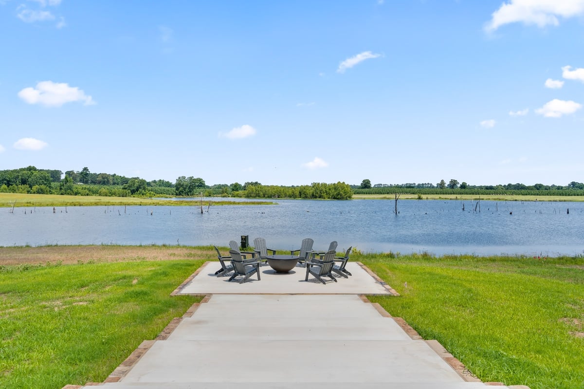lakeside fire pit seating area with water views in longview texas custom home