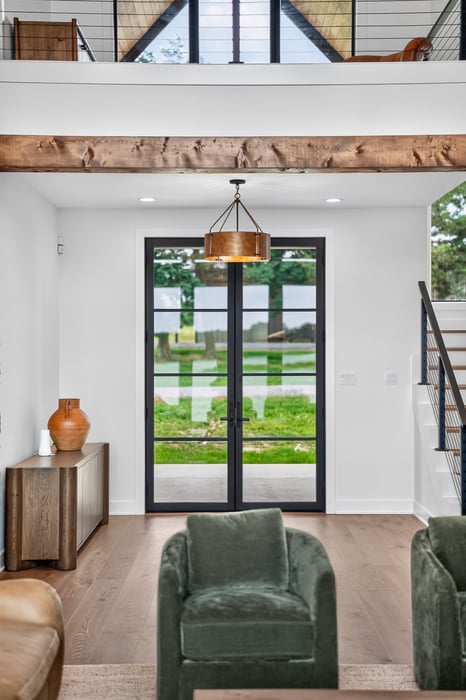 living room view toward black framed exterior doors in longview texas custom home