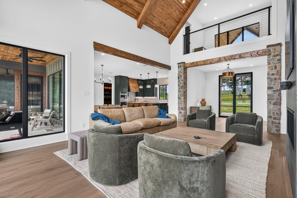 open concept living room with exposed wood beams in longview texas custom home