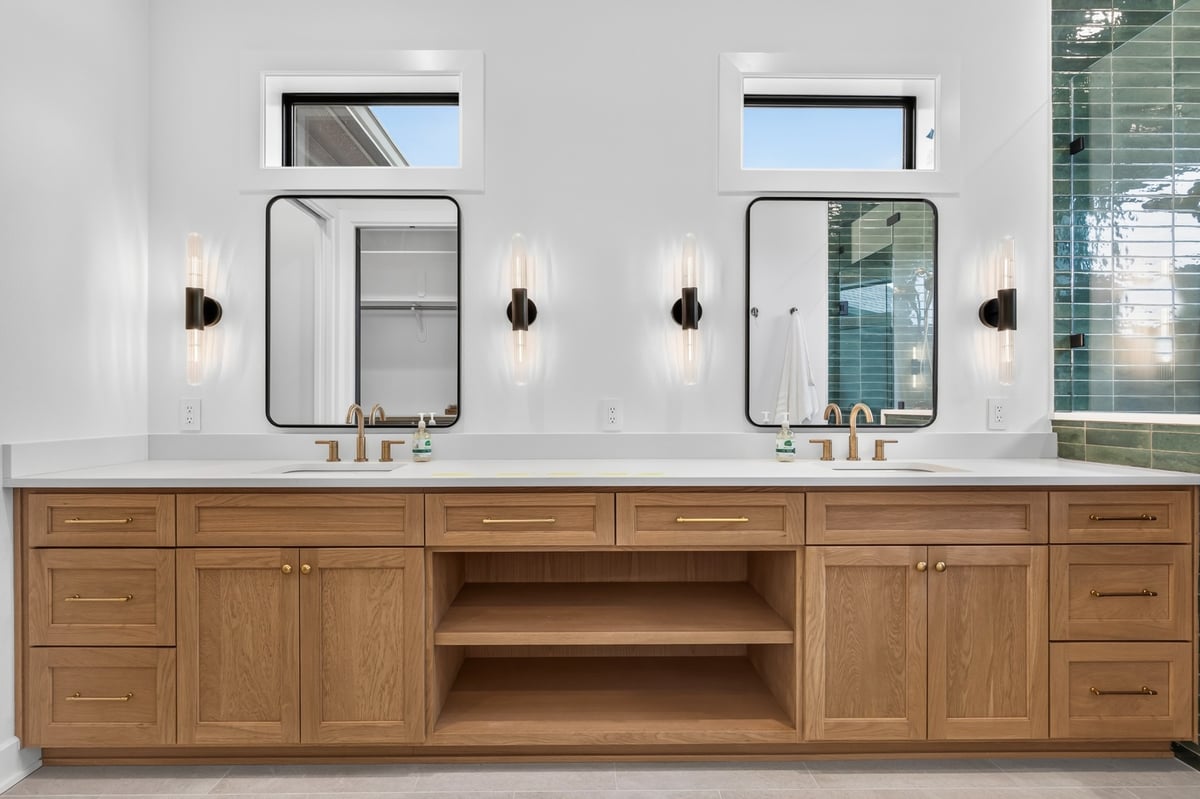 primary bathroom double vanity with wood cabinetry in longview texas custom home
