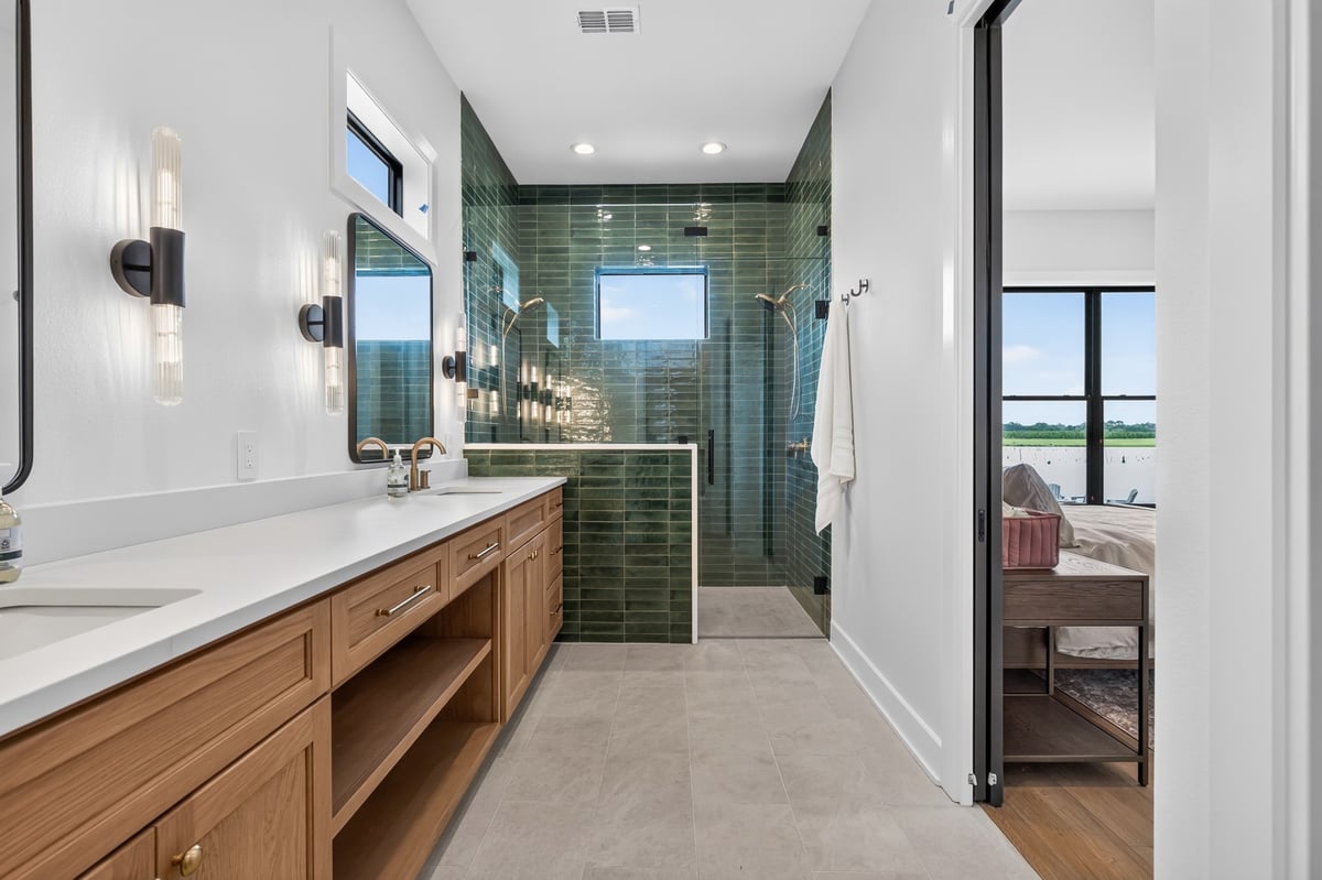 primary bathroom with green tile walk in shower in longview texas custom home