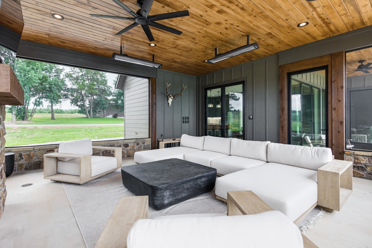 screened porch with white outdoor sectional in longview texas custom home