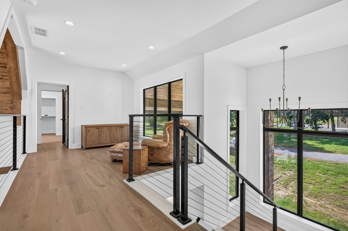 upstairs loft hallway with cable railing in longview texas custom home