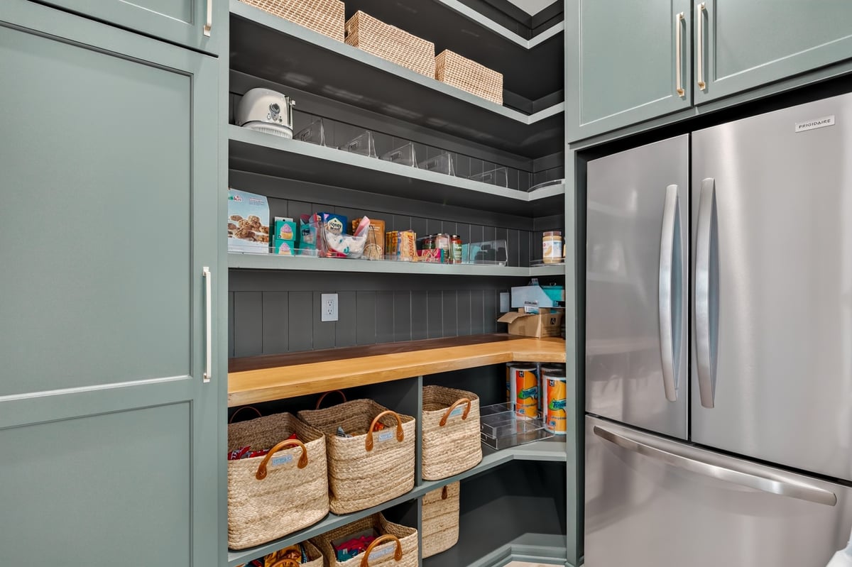 walk in pantry with custom shelves and baskets in longview texas custom home