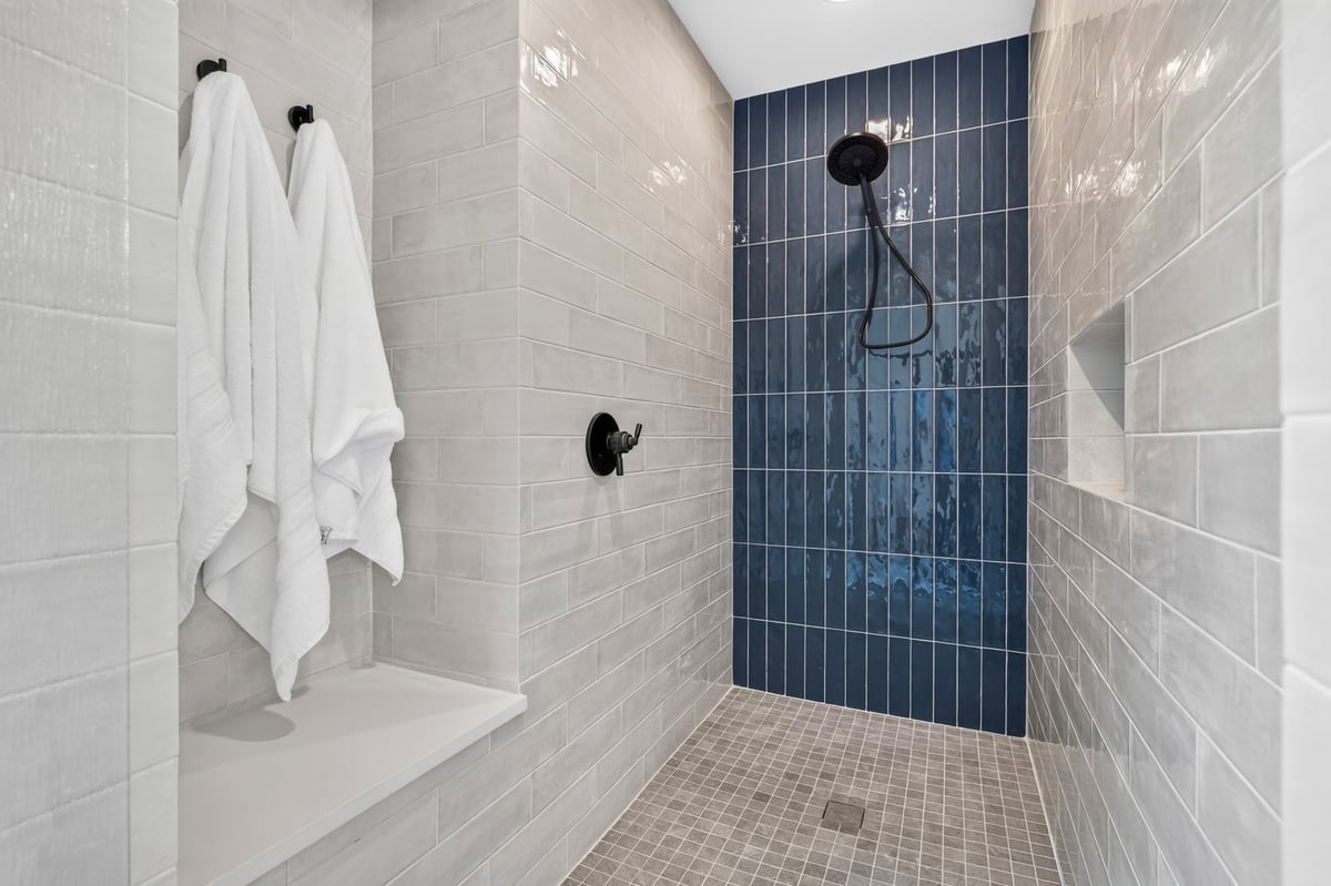 walk in shower with blue accent tile wall in longview texas custom home
