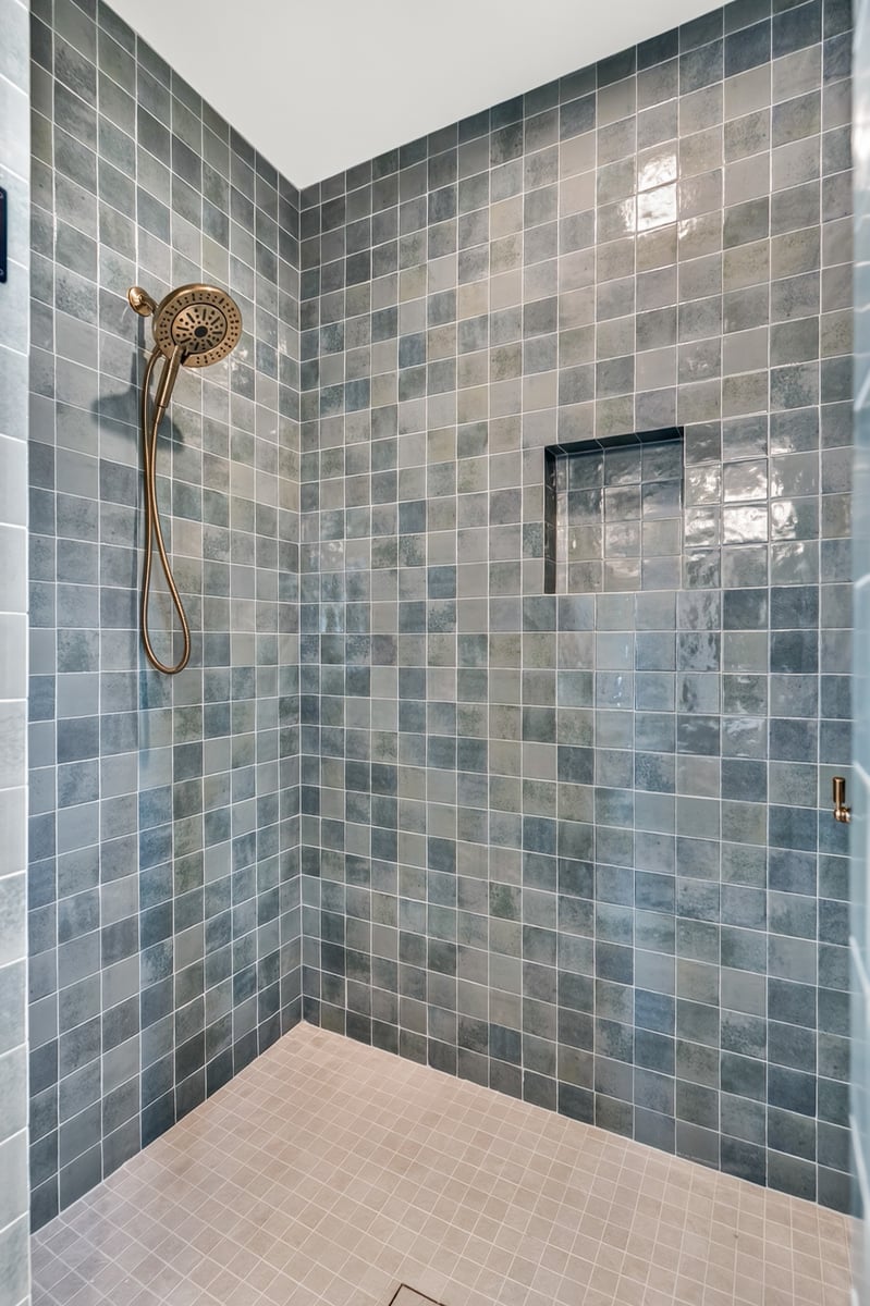 walk in shower with glossy green tile and built in niche in longview texas custom home