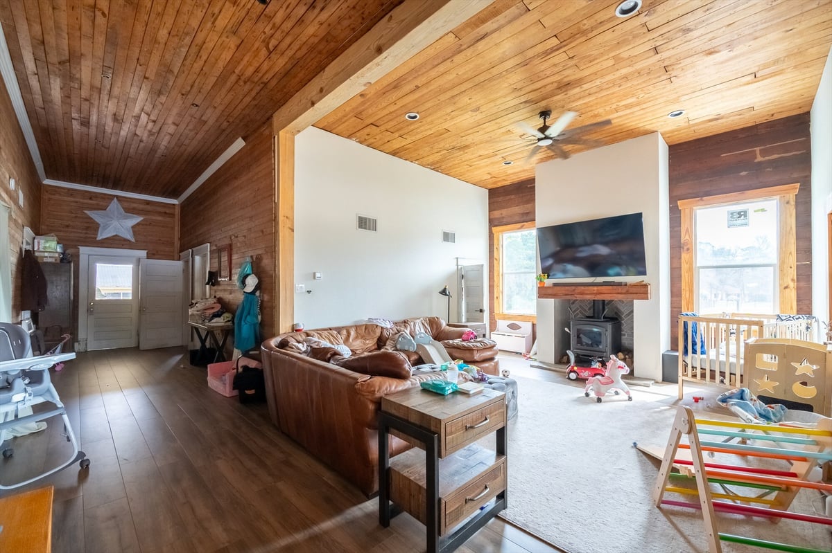 before east texas home remodel living room wood plank ceiling wood stove bort custom homes