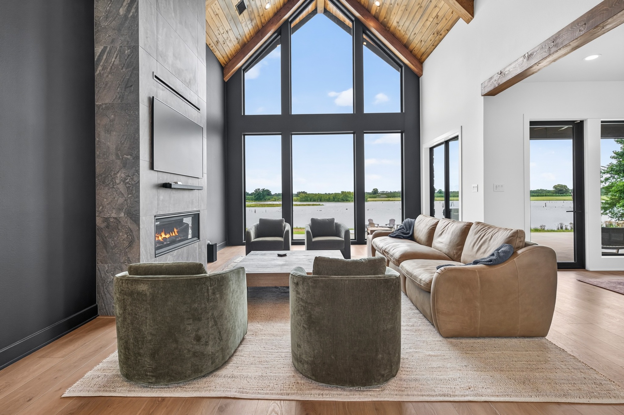 great room with vaulted wood ceiling and lake view windows in longview texas custom home