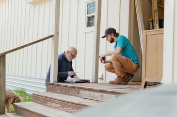 Bort Design professionals conducting a custom home construction consultation outside a home in Longview, TX.-optimized