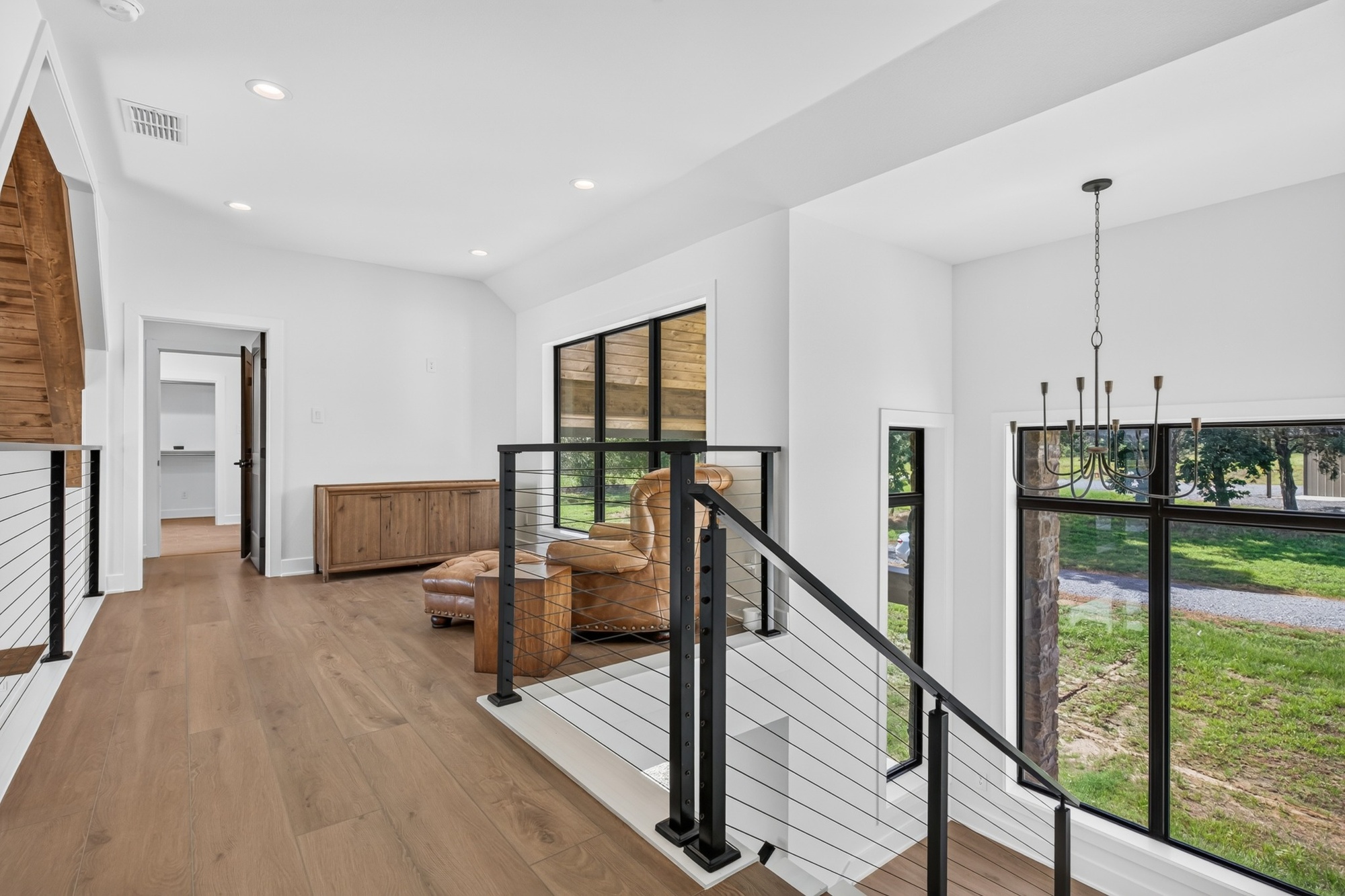 upstairs loft hallway with cable railing in longview texas custom home